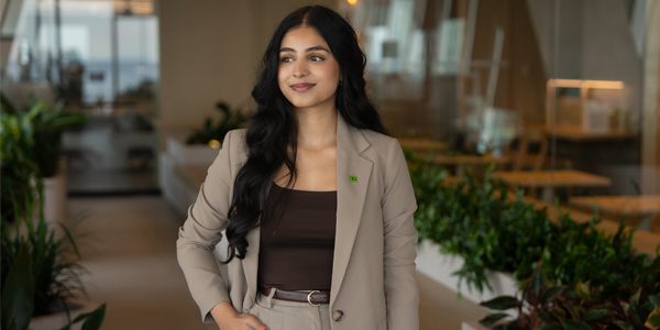 A new colleague smiles at a TD bank branch.