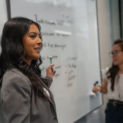 A colleague looks at her laptop while seated at a desk in a TD office.