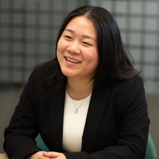 Two colleagues sit in a TD office to review business on a laptop.