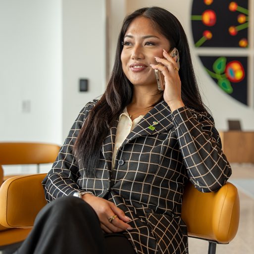 A TD colleague gestures with their hands while speaking to another colleague in their office.
